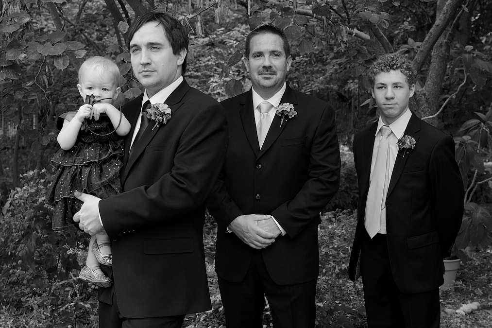 Joel, his daughter and groomsmen await the start of the wedding ceremony at Gazebo on the Green in Iowa City, Iowa.