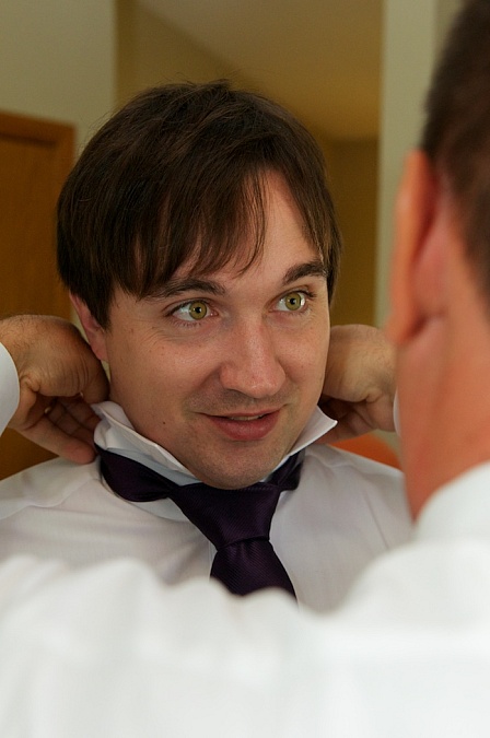 The groom dresses for his wedding.