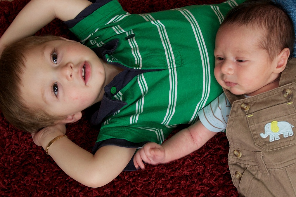 Brothers in first photo sesison together. Family, baby and individual portrait sessions are available on location throughout Eastern Iowa.