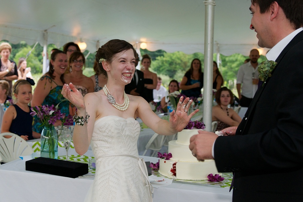 Candids of the cake cutting during their wedding reception.